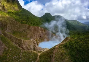 Top 10 World Places to Go in 2024 | Dominica, The Caribbean A bird’s-eye view of rainforests, reefs, and a boiling lake